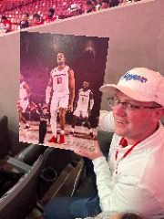 Conrad writes: “Our son, Tyler, with a sign that my wife Kristy made, for hosting ESPN College GameDay inside Fertitta Center in February. For a laugh… Zoom in under J’Wan Roberts’ right hand to see who is standing there… Thanks, Kristy!”